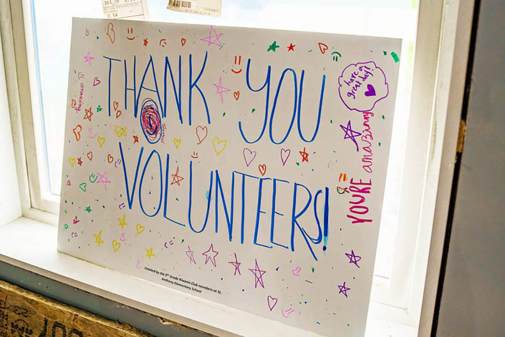 handmade sign reading "Thank you volunteers" with stars, hearts and smilley faces