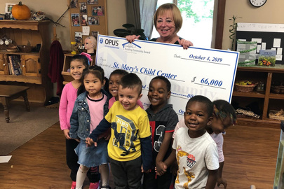 Children at St. Mary's Child Center smiling during the 2019 Opus Foundation's Building Community Award check presentation