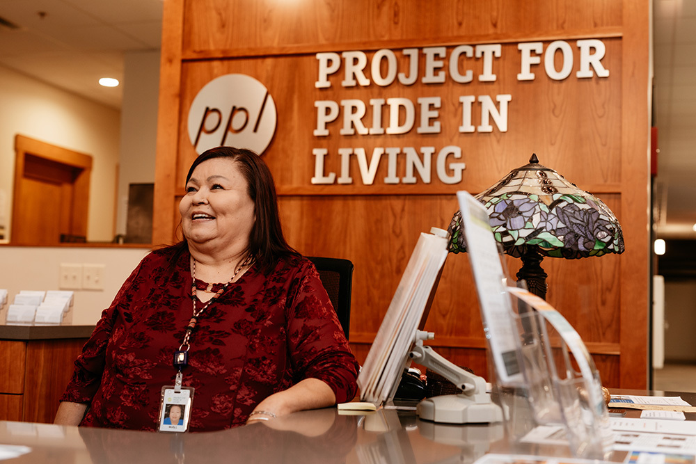 Woman at Project for Pride in Living desk