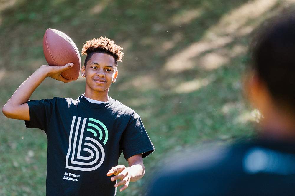 boy with footbal Brother Big Sisters Twin Cities