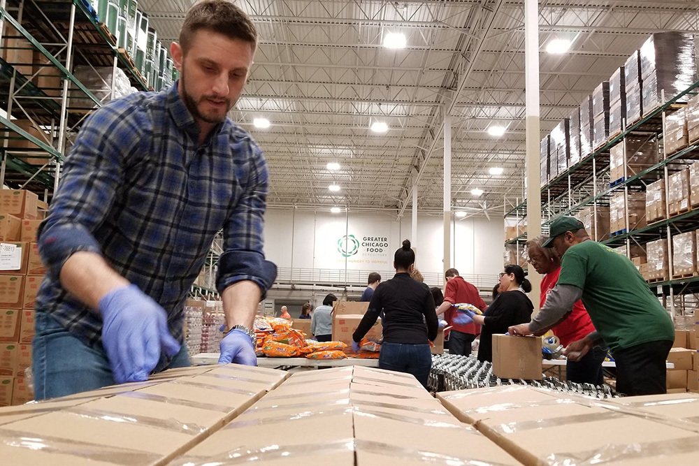 man packing food at Great Chicago Food Depository