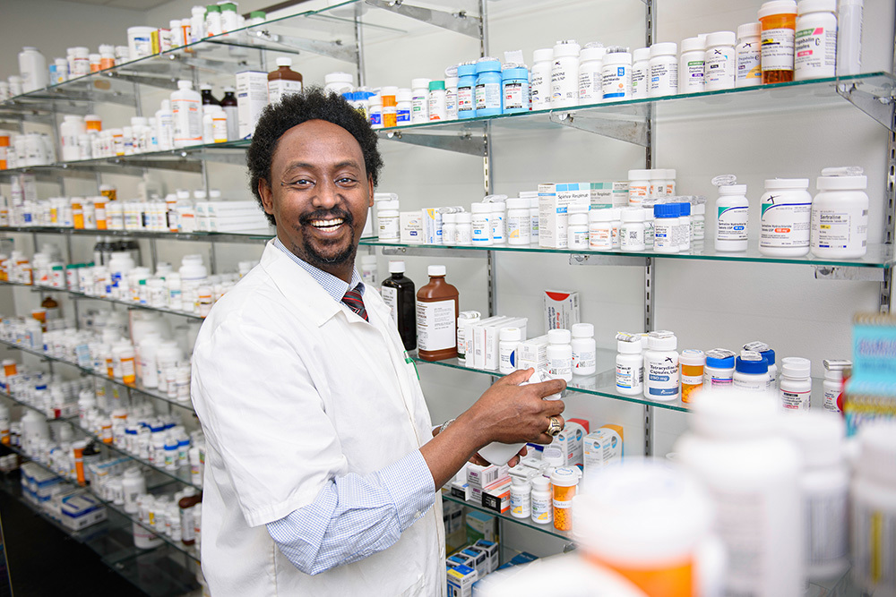 man standing in pharmacy
