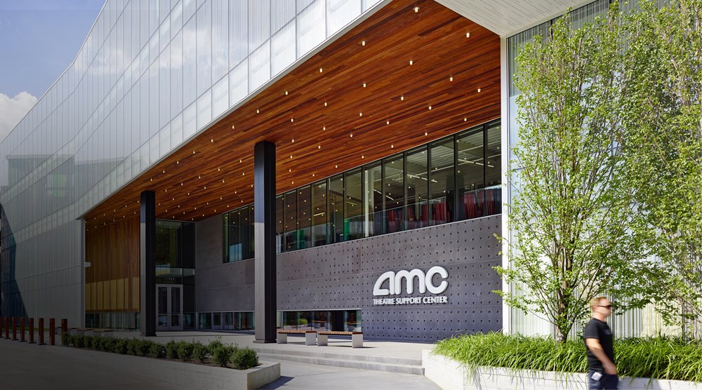 exterior of office building with "AMC Theatre Support Center" sign on front near entrance