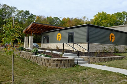 Exterior of a new building with a pergola entrance.