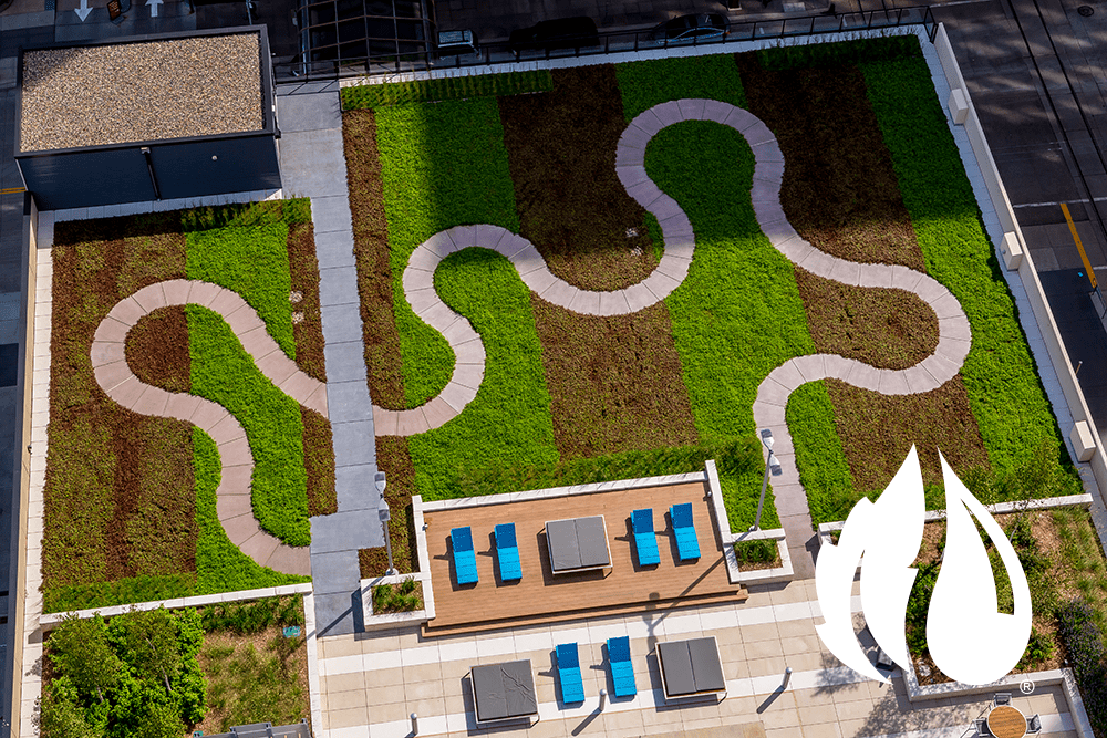 The green roof walking path of an apartment building looked at from a higher point in the building.