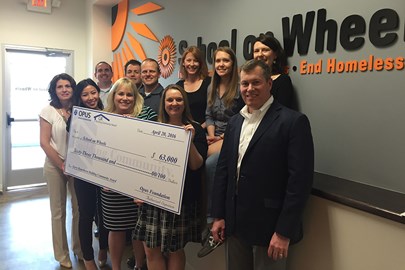 Opus associates surprised School on Wheels with a check for $63,000
