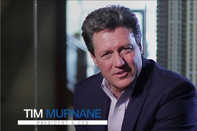 man in professional attire with words "Tim Murnane, President & CEO"