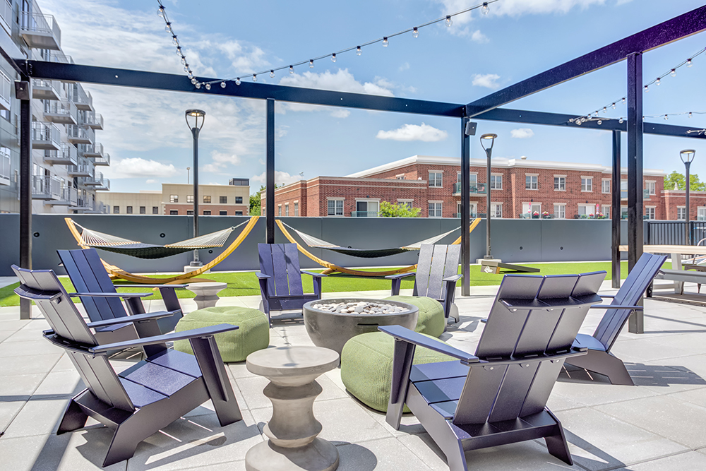 the clubroom, Luxer-enabled package room, work-from-home suites, pet spa and outdoor amenity deck at The Marke of Elmhurst