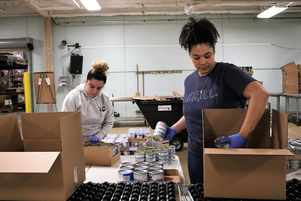 Greater Chicago Food Depository women filling boxes with canned food