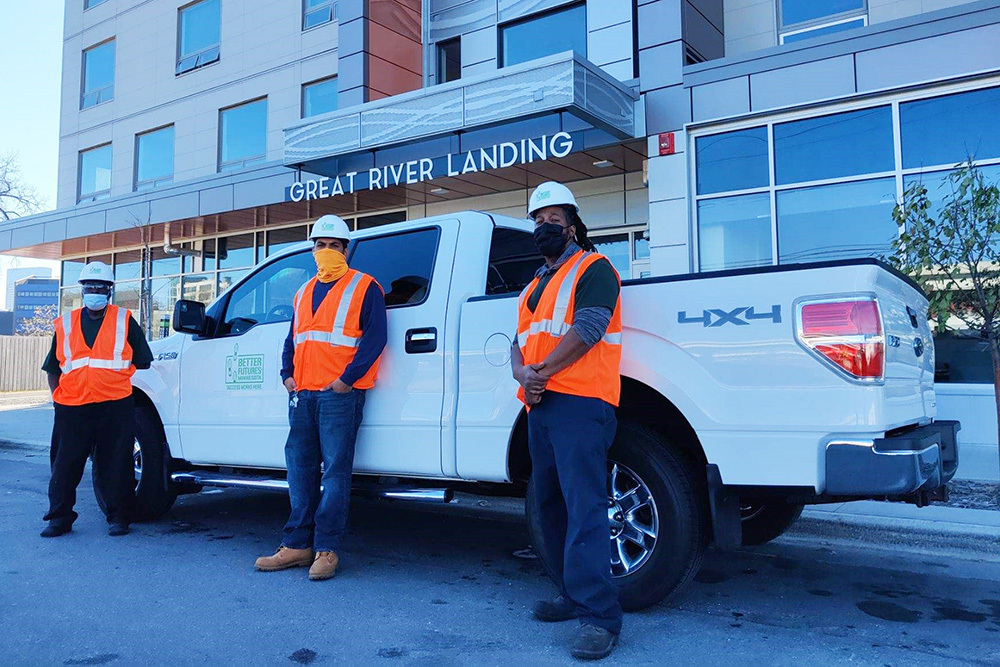 three men pose in front of Better Futures Minnesota’s new work pickup