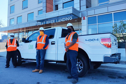 three men pose in front of Better Futures Minnesota’s new work pickup