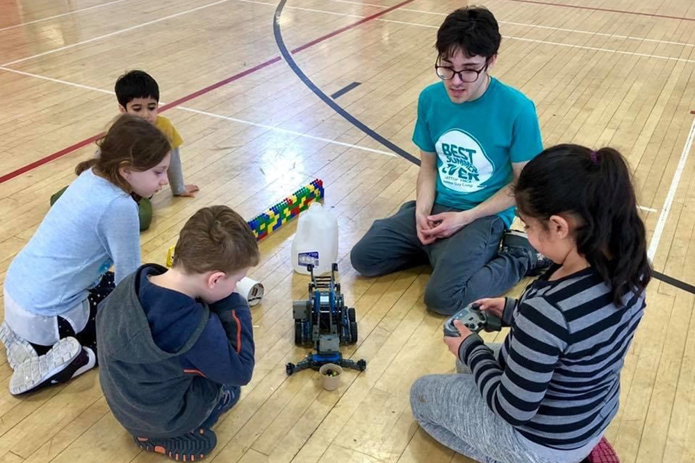 group of kids playing with robotics