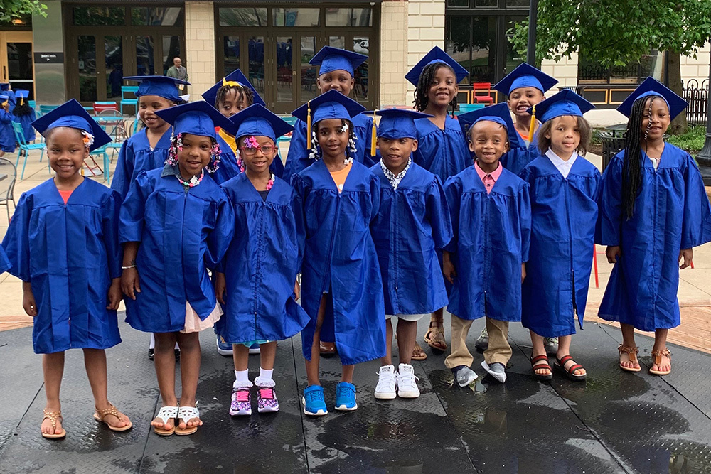 group of young children in graduation caps and gowns at North Side Community School