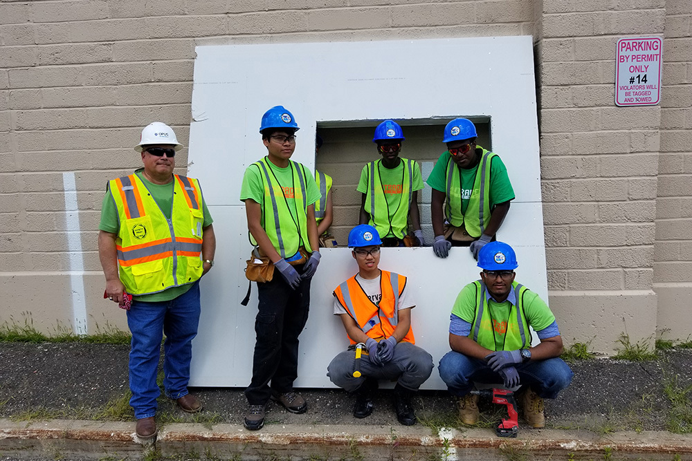 group picture of youth in vests and hard hats