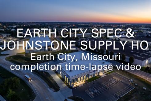 words "Earth City Spec and Johnstone Supply HQ, Earth City, Missouri, completion time-lapse video" written in foreground with aerial view of industrial buildings in background