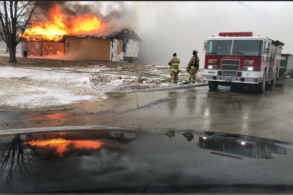 firetruck puts out burning building during firefighter training