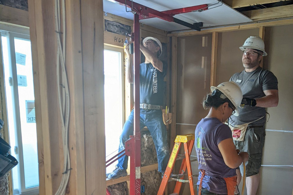 men and women inside house under construction