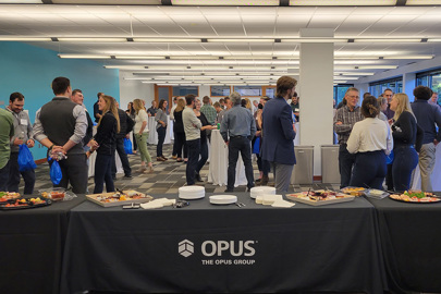 men and women in a conference room with Opus logo on tablecloth