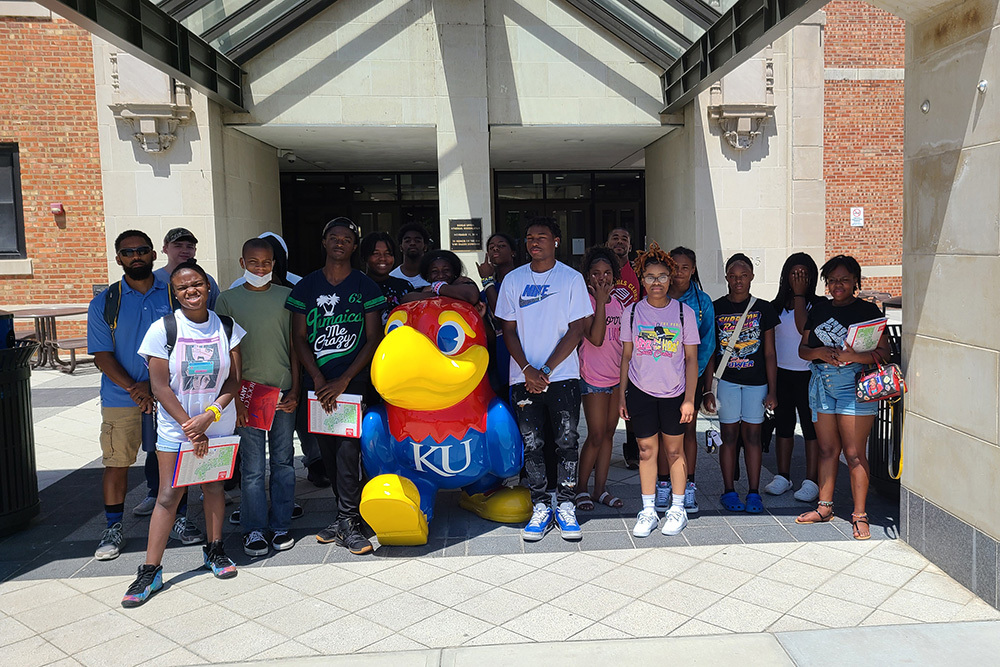 group of children outside with KU mascot
