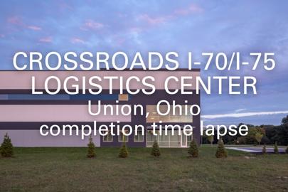 words "Crossroads 1-70/I-75 Logistics Center, Union, Ohio, completion time lapse" written on foreground with exterior of industrial building in background