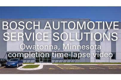 words "Bosch Automotive Service Solutions, Owatonna, Minnesota, completion video time-lapse video in foreground and exterior of industrial building in background