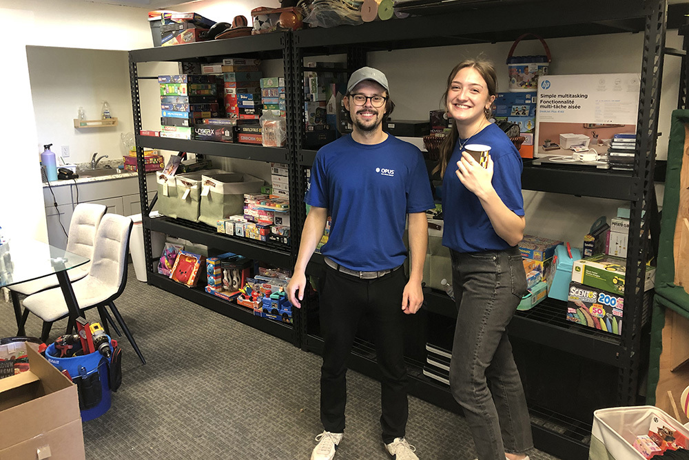 man and woman in front of stocked shelving