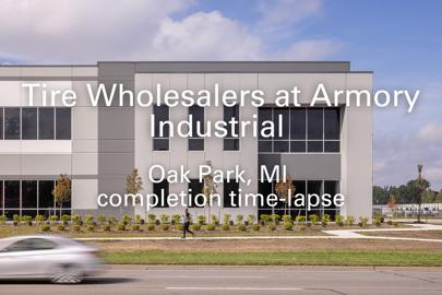 Exterior of industrial building with words "Tire Wholesalers at Armory Industrial, Oak Park, MI, completion time lapse" in foreground