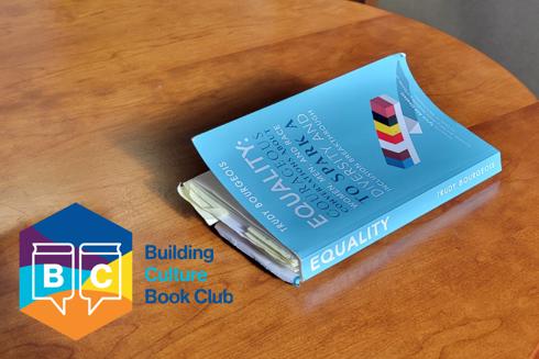 blue book sitting on a table on right and logo in bottom, left corner with words "Building Culture Book Club"