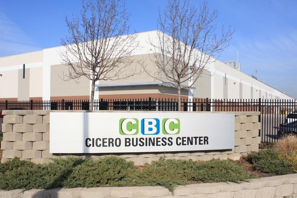 sign reading "Cicero Business Center" in foreground with industrial builing in background