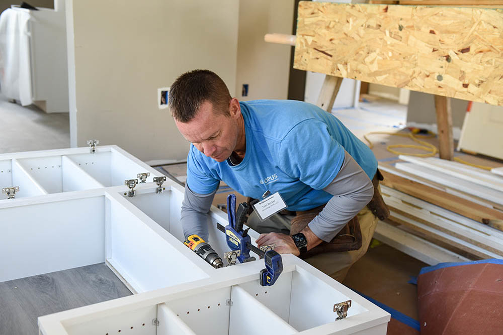 Becker, Newins Get Their Hands Dirty at Annual CEO Build - Opus