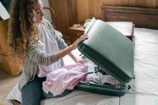 girl closing suitcase