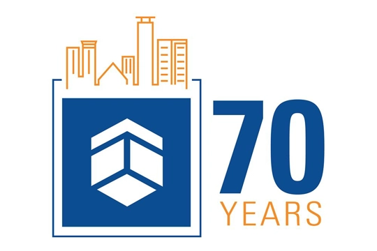 graphic with shield logo with blue background inside a square with outline of a city skyline on top and words "70 Years" on right