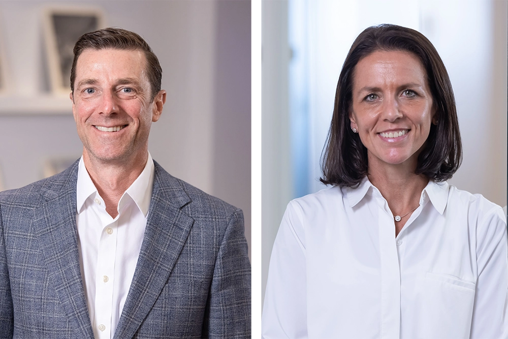 two smiling people in professional attire