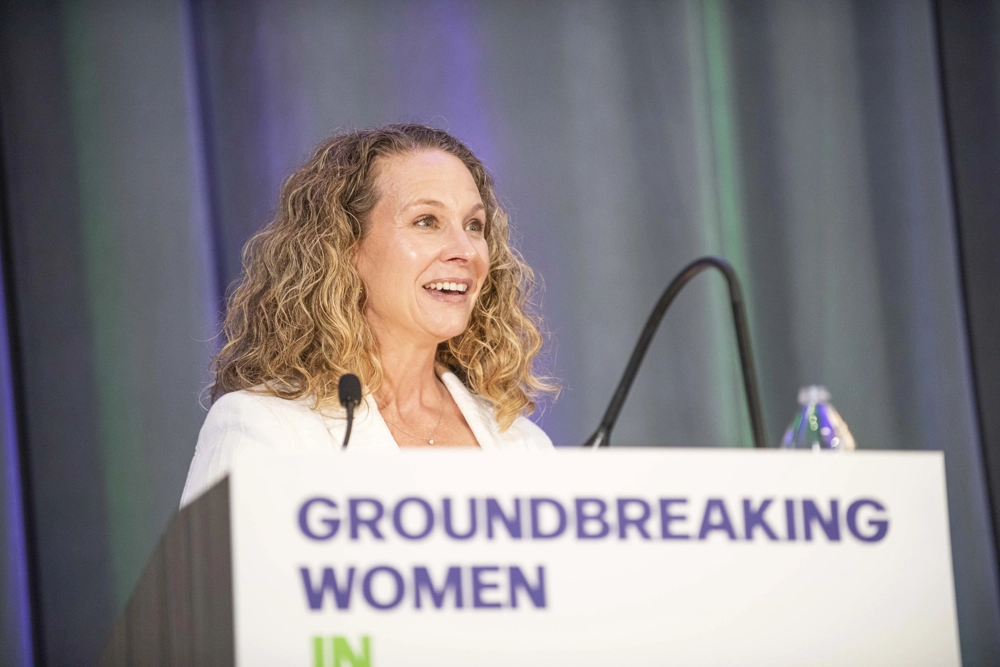 Women speaking behind podium