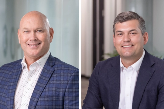 two smiling people in professional attire