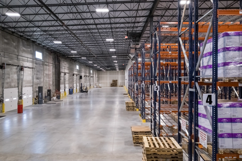 rows of shelving in warehouse of industrial building