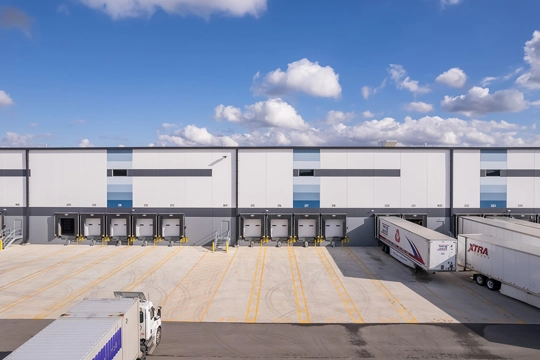 Dock doors with trailers on the back side of an industrial building