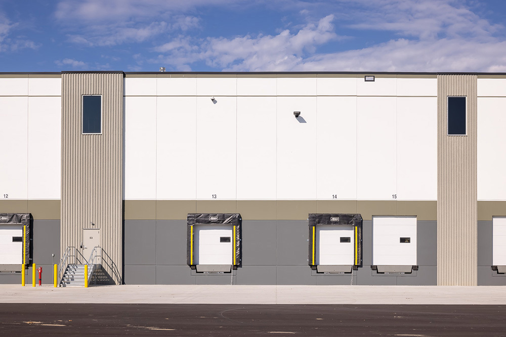 Rear dock doors for trucks to access on a speculative industrial building and an entrance for people