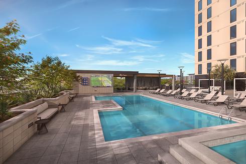 rendering of rooftop outdoor living area of an apartment building showing pool deck