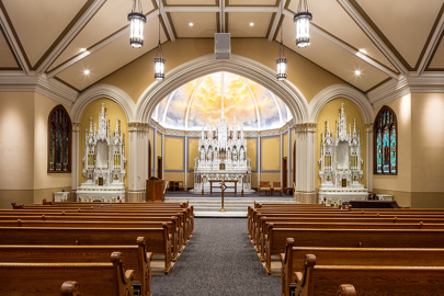 interior of a church with rows of pews in the foreground and the alter, pulpit and stage in the background