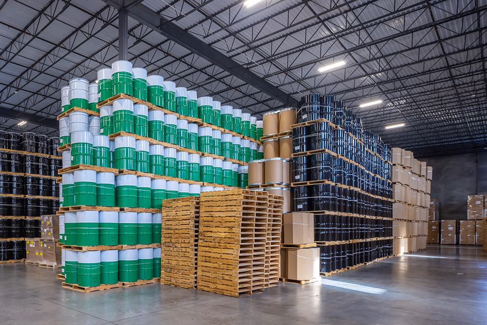 interior of industrial warehouse with stacked pallets of barrels