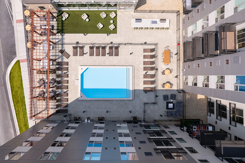 aerial view looking down on rooftop outdoor living area of residential building