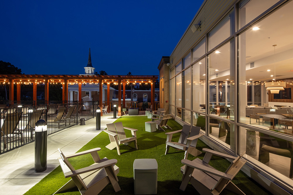 night view of apartment building's rooftop outdoor living area