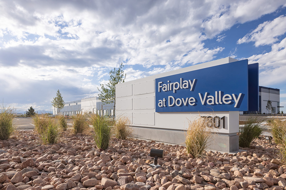 Monument sign for a building with the words Fairplay at Dove Valley