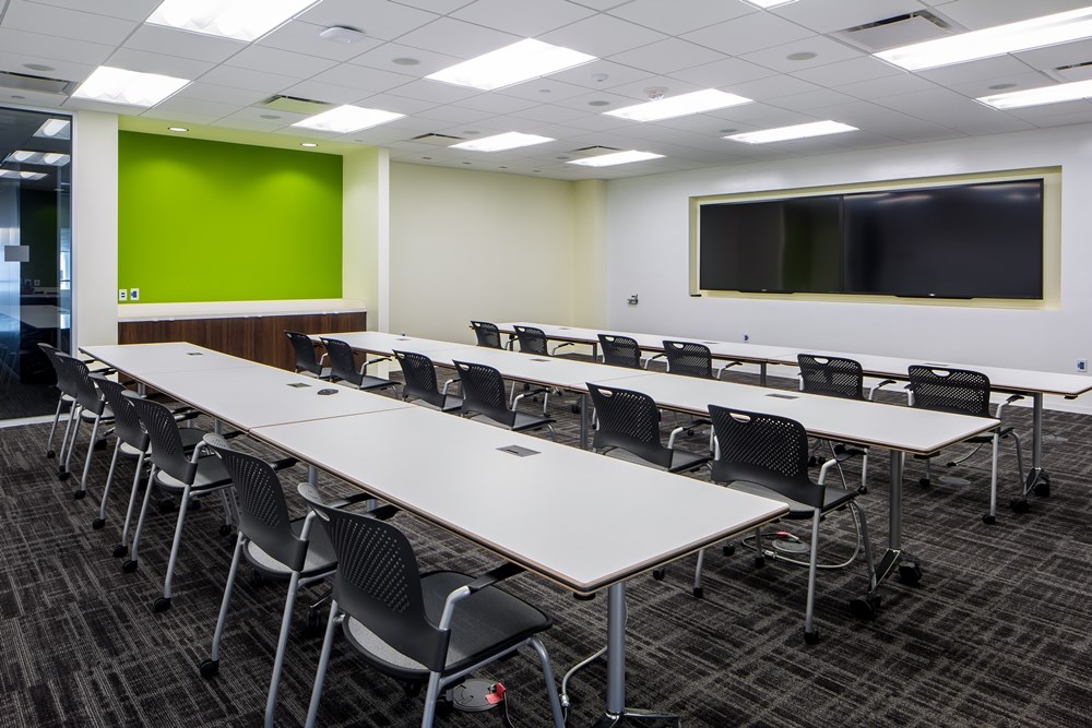 conference room in an office building with rows of tables with chairs
