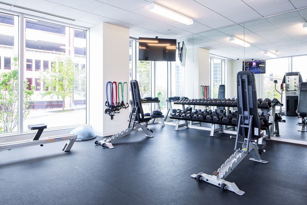 fitness center in an office building with exercise equipment and weights