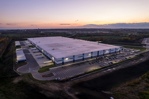 aerial view of industrial building at sunset