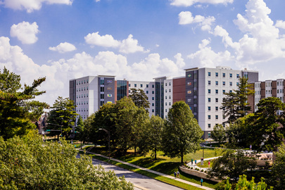 aerial view of university residence hall with street and treetops in foreground