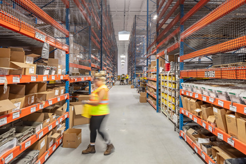 warehouse in an industrial building with tall shelves filled with items