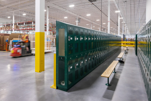 warehouse in an industrial building with rows of lockers and benches